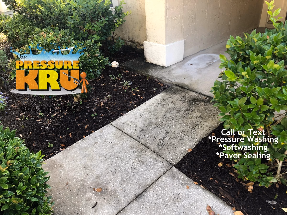 Concrete driveway restored with hot water pressure washing in Jacksonville, FL. Before image.