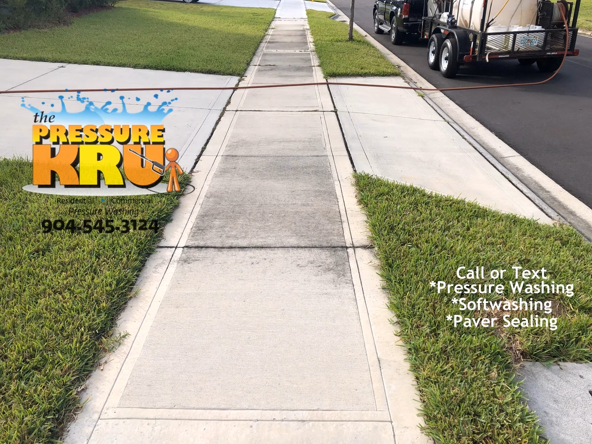 Residential concrete driveway cleaned with professional washing in St. Johns, FL. Before image.