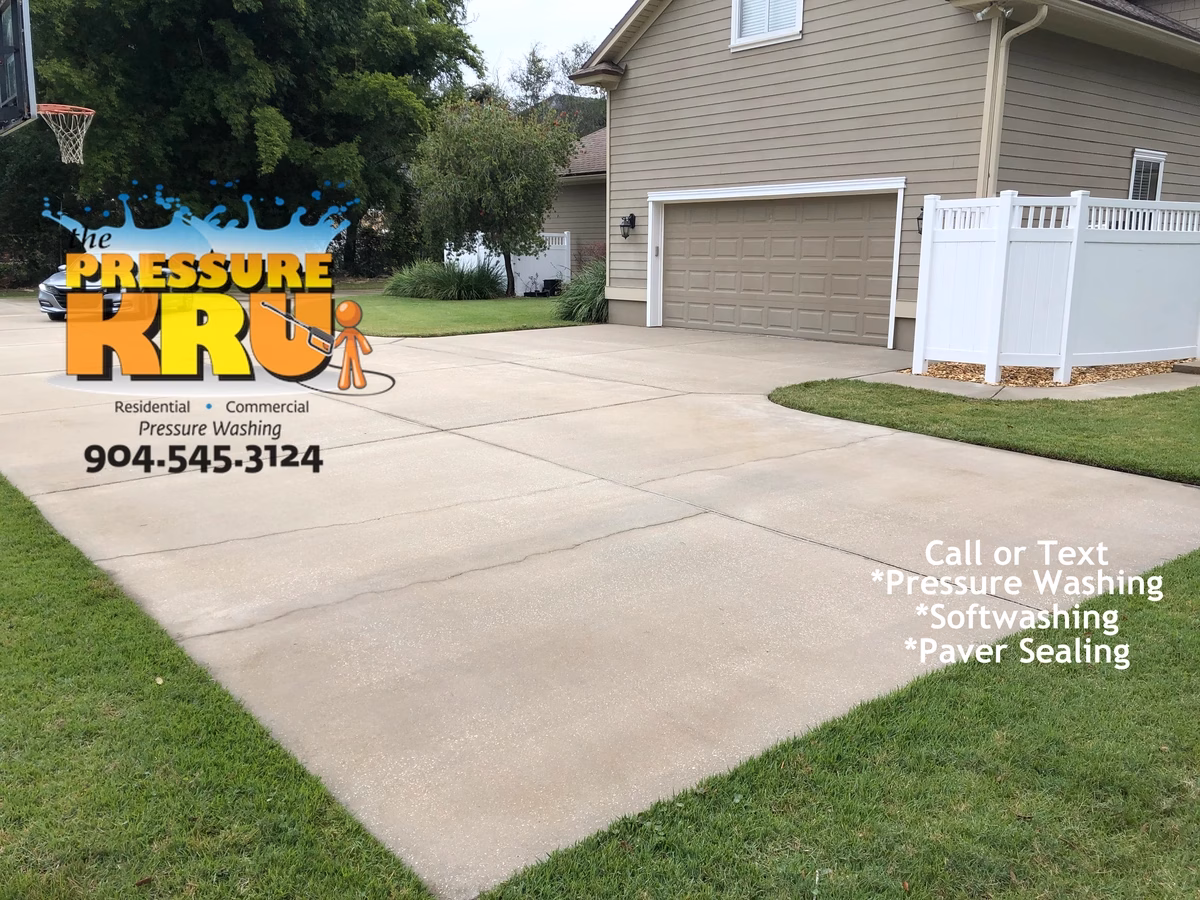 Concrete driveway pressure washing in St. Johns, FL. after removing mold and mildew from surface.