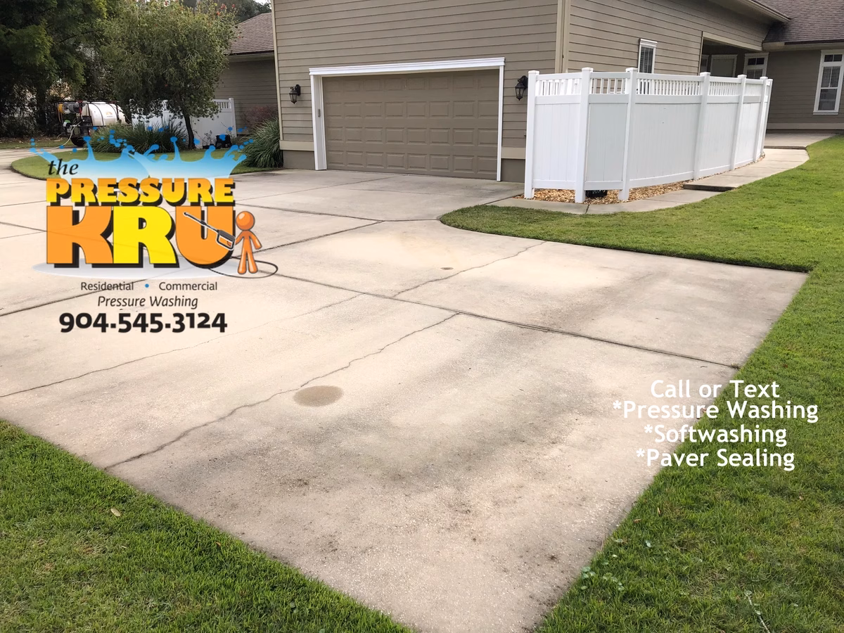 Concrete driveway pressure washing in St. Johns, FL. before removing mold and mildew from surface.