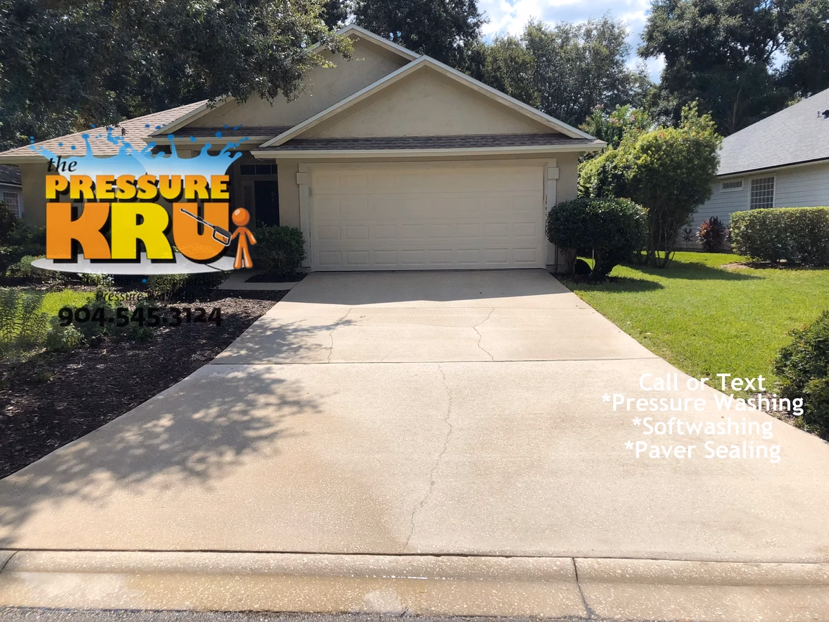 Driveway pressure washing in St. Augustine, FL. after removing mold and algae. Notice uniformity of cleaning service that also took out the stripes.