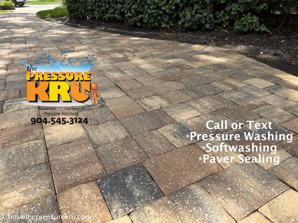 Residential paver driveway after pressure washing in Queen's Harbor.