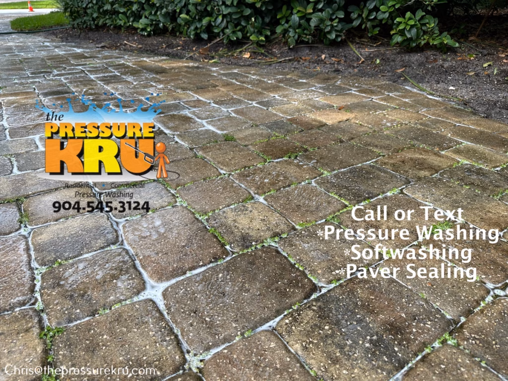 Residential paver driveway before pressure washing in Queen's Harbor.