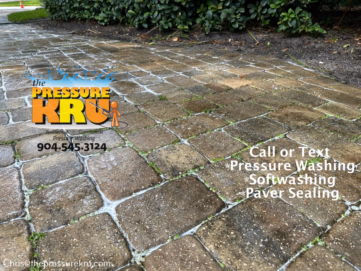 Residential paver driveway before pressure washing in Queen's Harbor.