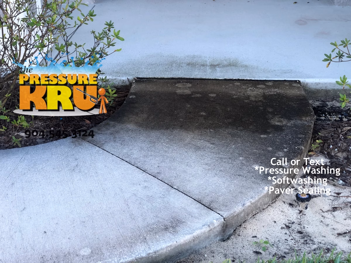 Concrete sidewalk cleaning service in St. Johns, FL before cleaning home exterior.