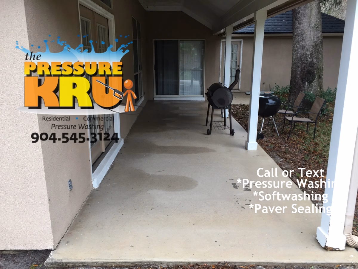 Concrete patio pressure washing in St. Augustine, FL after chemical treatment.