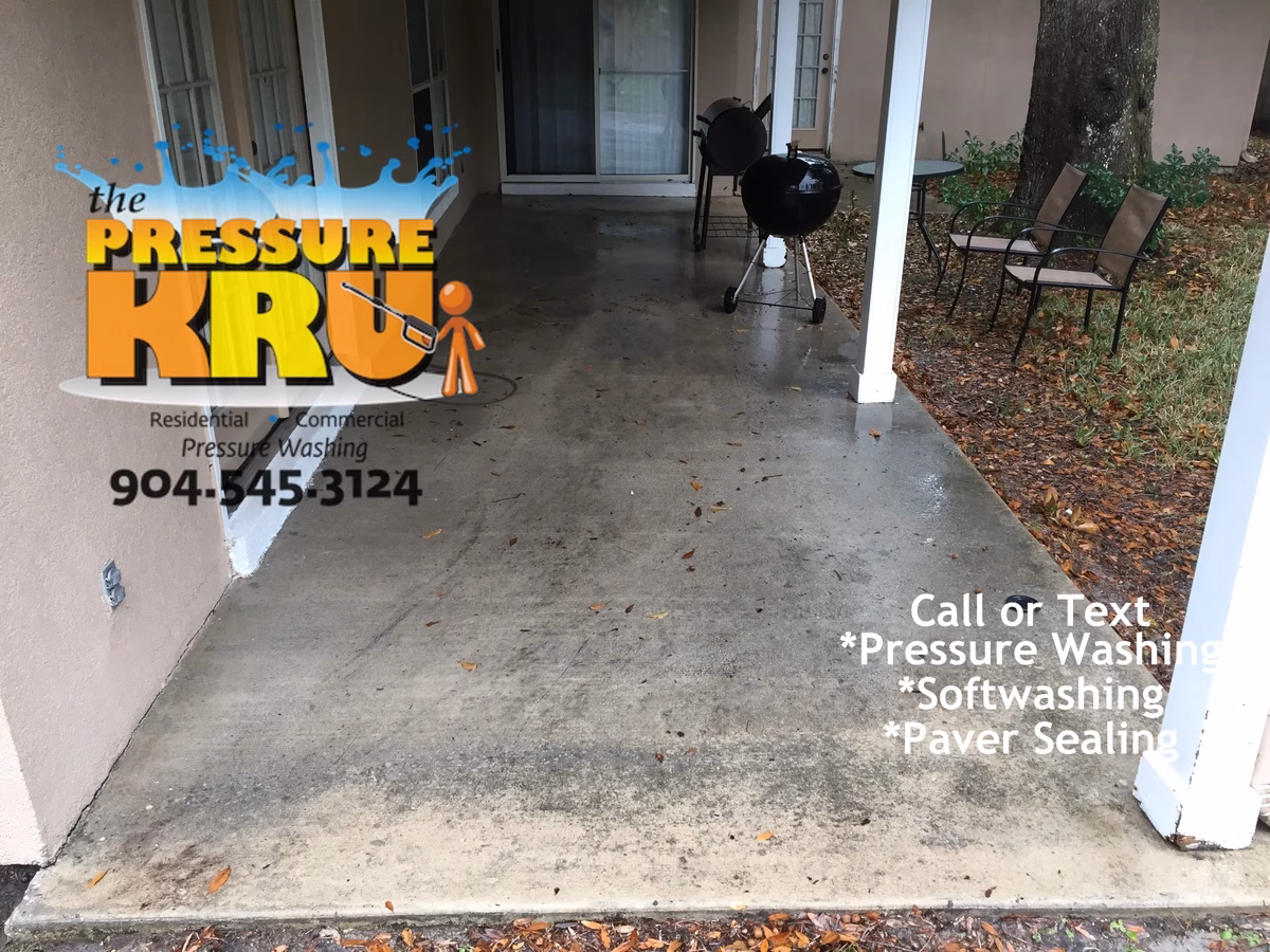Concrete patio pressure washing in St. Augustine, FL before chemical treatment.