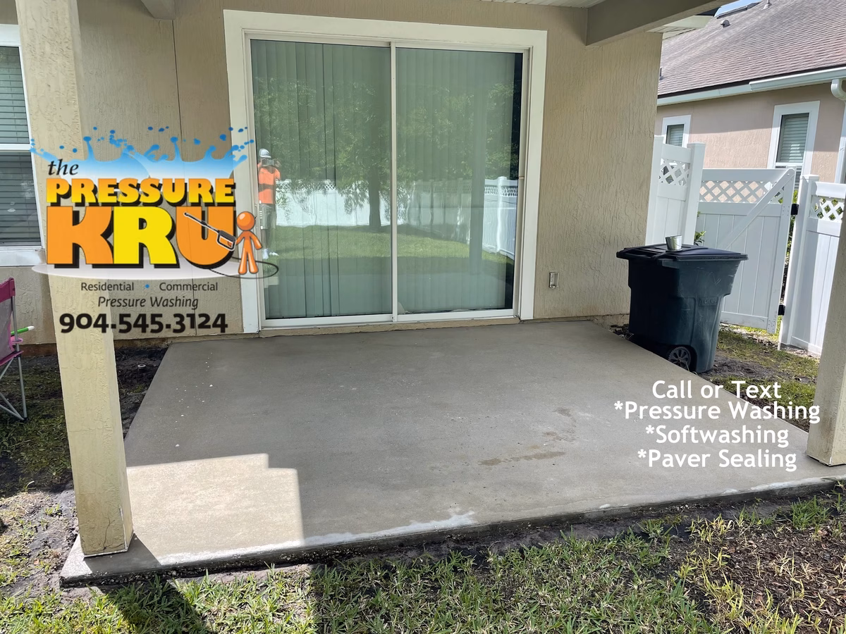 Concrete patio cleaning in St. Johns, FL after softwashing.