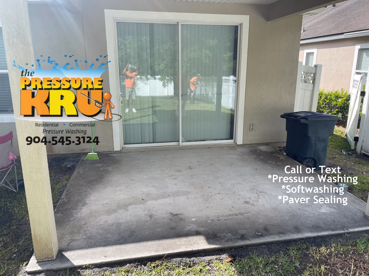 Concrete patio cleaning in St. Johns, FL before softwashing.