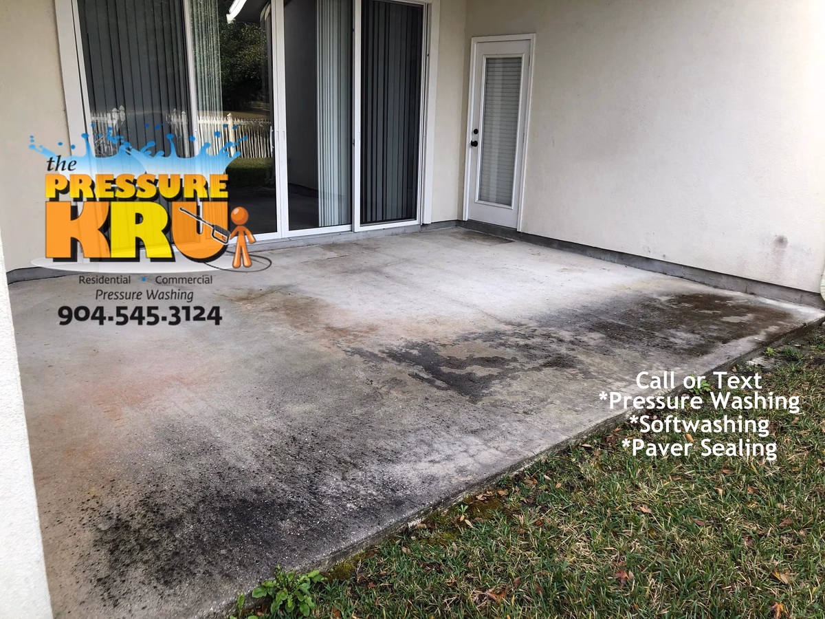 Concrete patio pressure washing in Jacksonville Florida before professional cleaning.