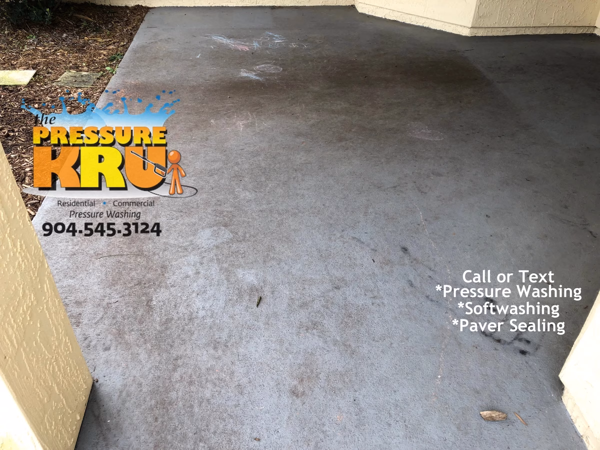 Pressure washing mud stained rear patio floor from dogs in St. Johns Golf & Country Club before
