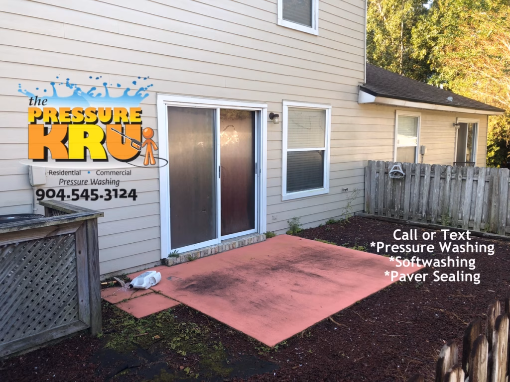 Pressure washing and soft washing a rear painted patio slab in South Bridge town home development before