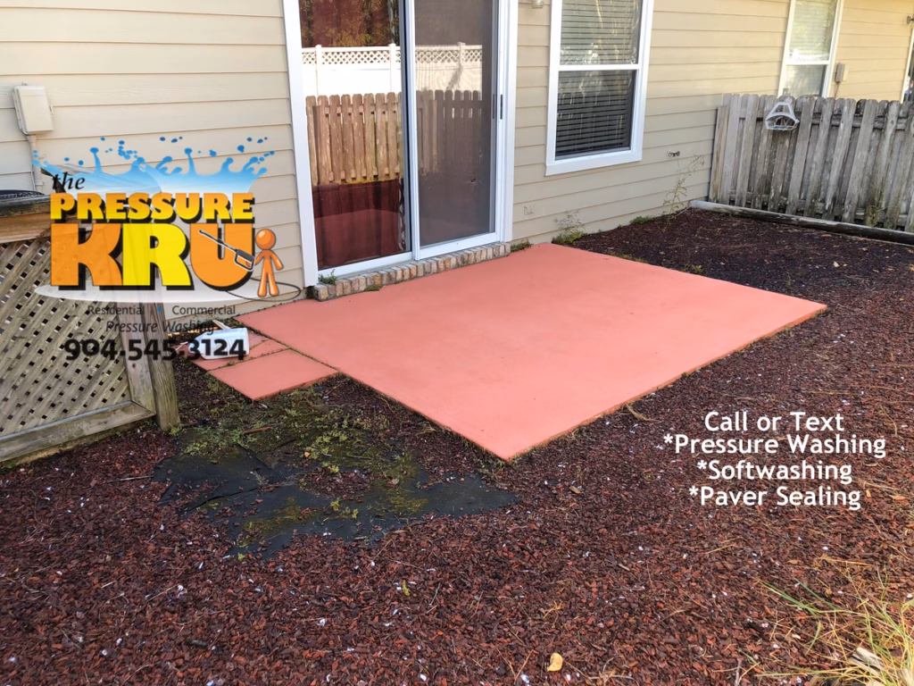 Pressure washing and soft washing a rear painted patio slab in South Bridge town home development after