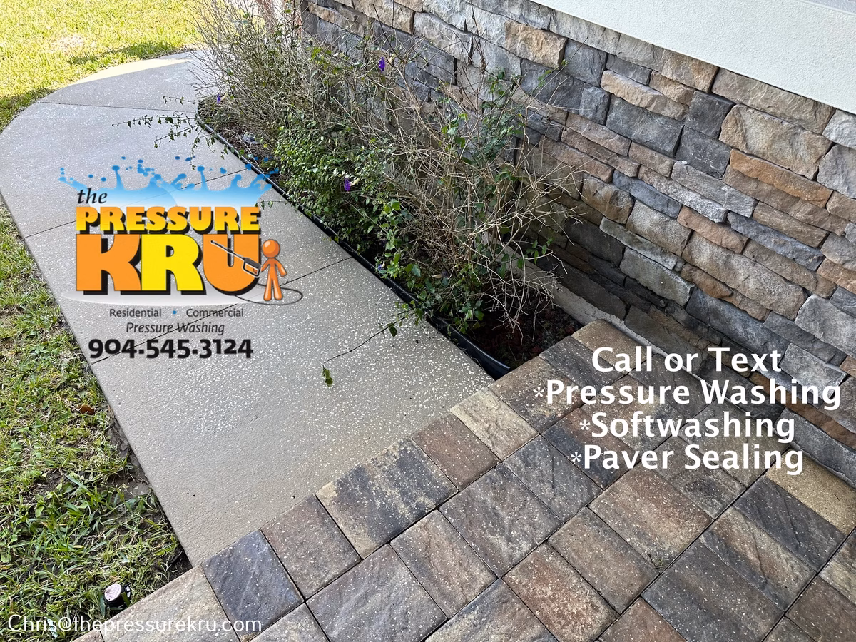 Applying eco-friendly cleaner to paver driveway after washing in Johns Creek.