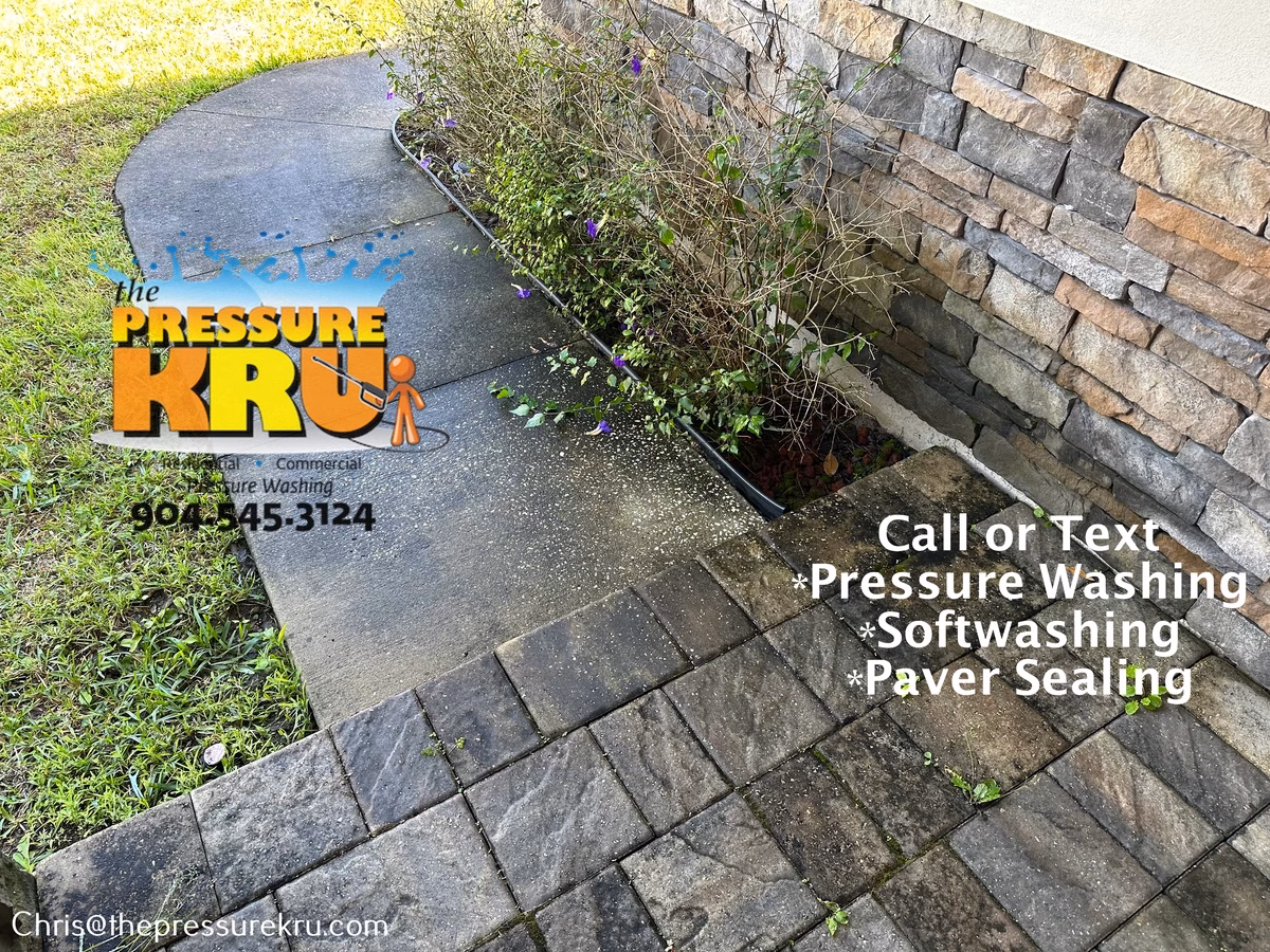 Applying eco-friendly cleaner to paver driveway before washing in Johns Creek.