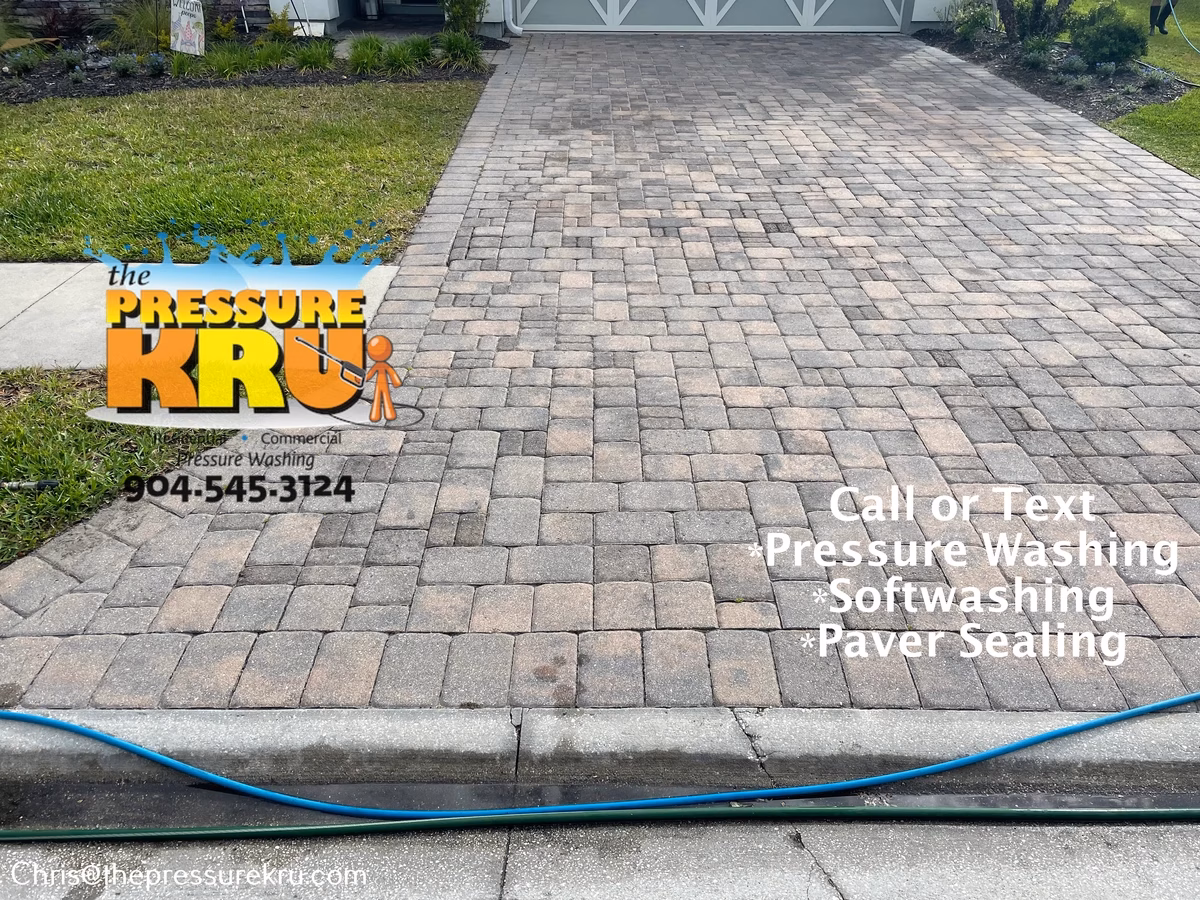 Oil stained paver driveway before pressure washing in Aberdeen.