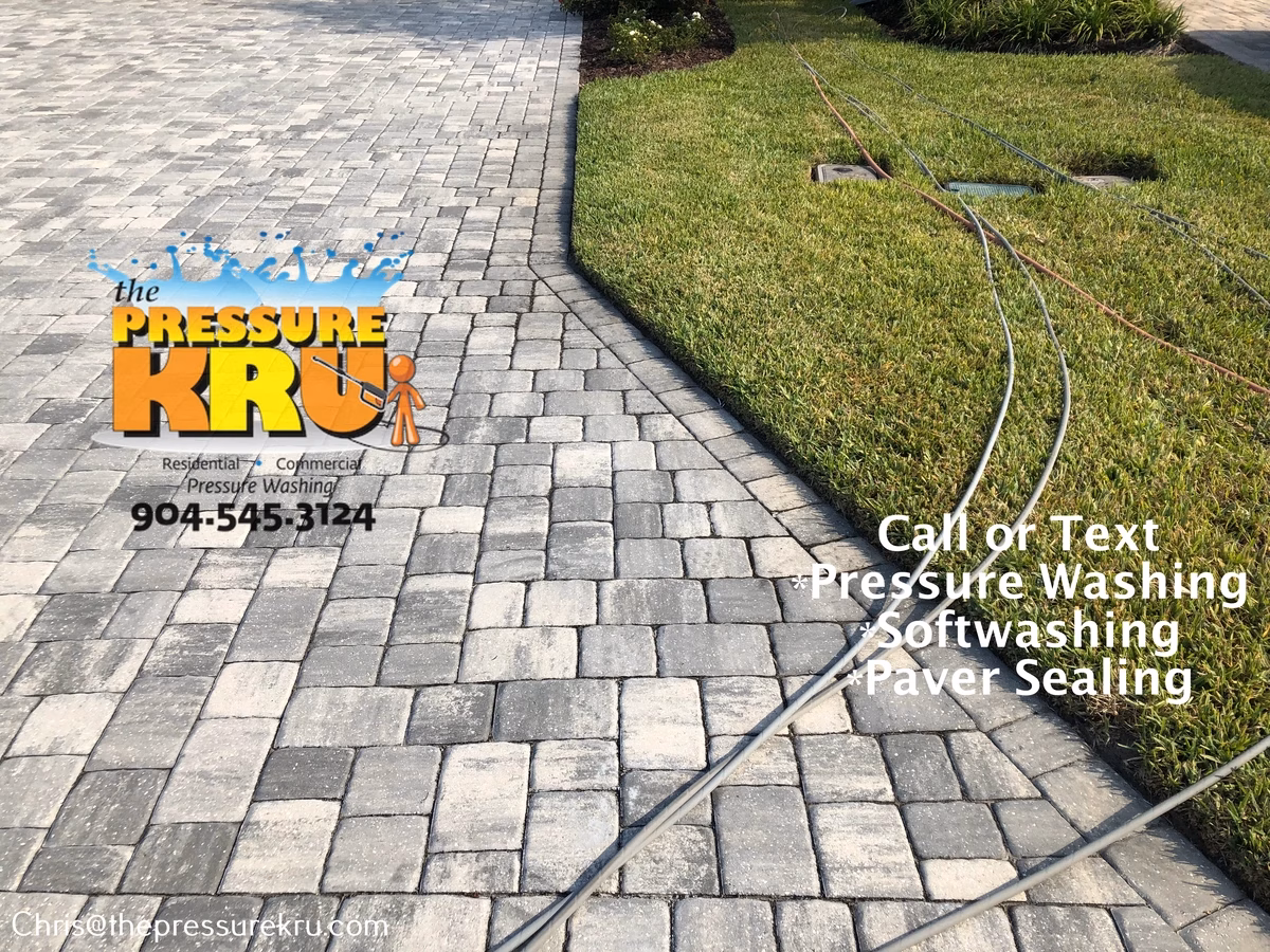 Paver driveway before pressure washing in Stillwater.