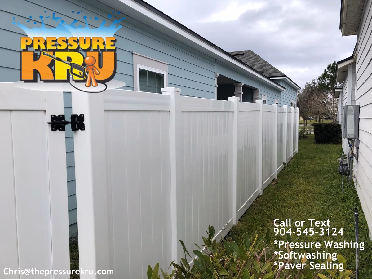 Fence cleaning in World Golf Village area showing green algae removed