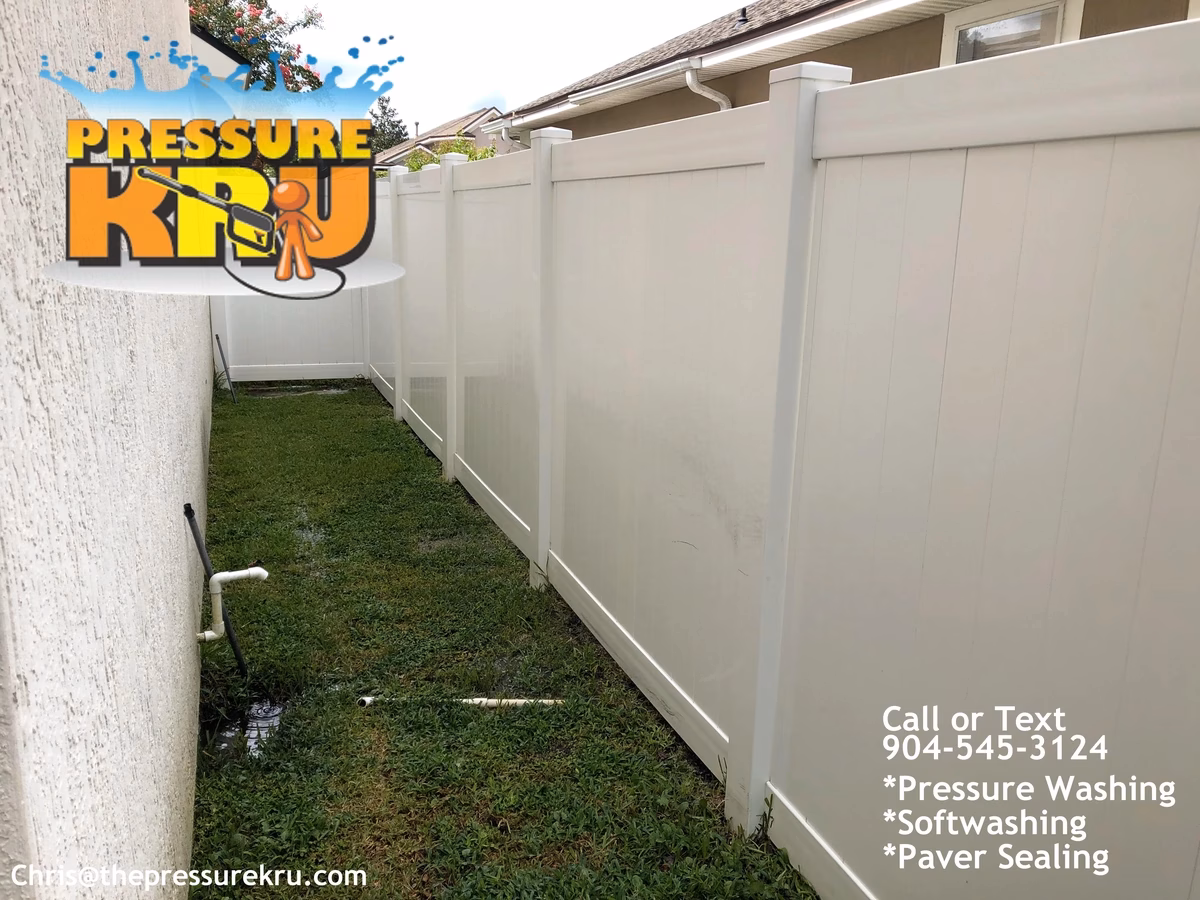 Vinyl fence after softwashing in Celestina showing green and black mold removed